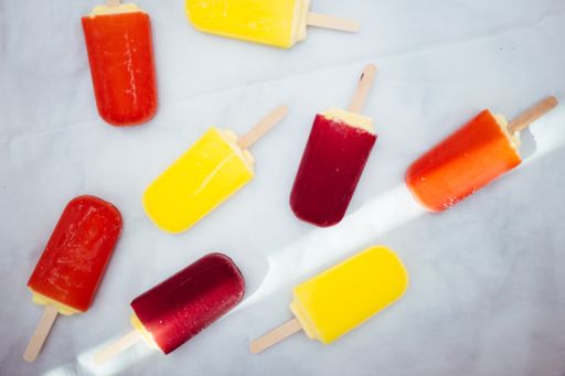 An aerial view of colorful popsicles in a blue background