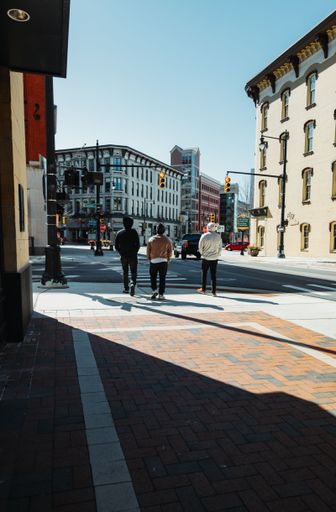 A rear view of cool young people walking through the city near Grand Rapids in the USA