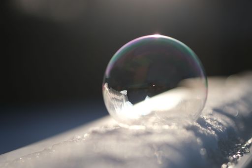 A closeup of a transparent shiny bubble isolated on the snow