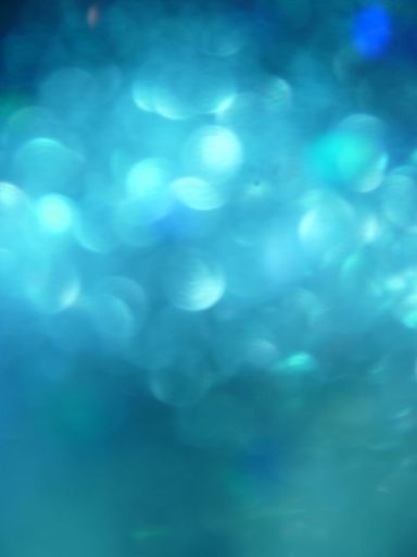 A vertical shot of blue lights under the lens flare effect