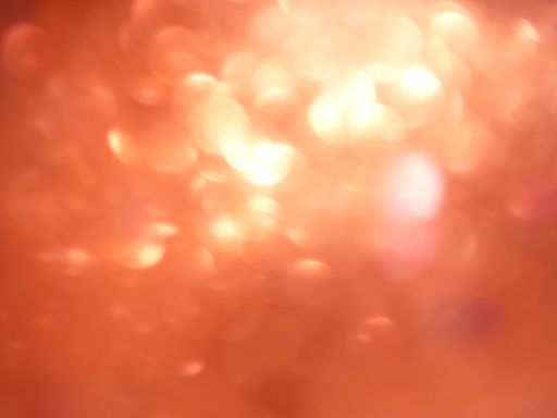 A closeup shot of red round lights under the lens flare effect