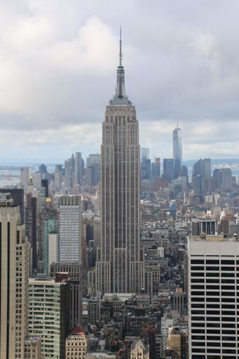 A vertical shot of the Empire State Building from the top of a skyscraper in New York City, USA