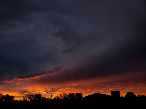 A view of a sunset over the town in navy and orange colors