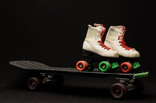 Vintage Style Black Skateboard and Skate Boot on a Dark Background