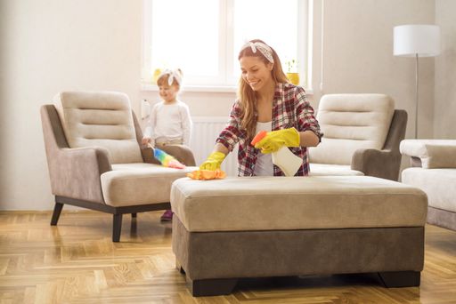 A daughter and mother cleaning home together and having fun