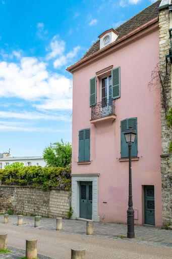 Paris, France, famous pink house and buildings in Montmartre, in a romantic street
