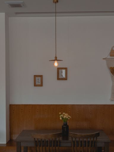 A vertical shot of a yellow lamp hanging from the ceiling