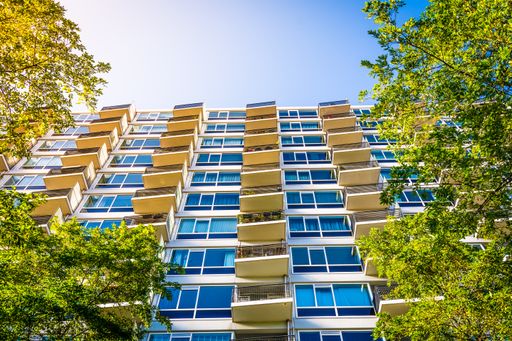 A low angle shot of symmetrical balconies on a modern building under a bright sky