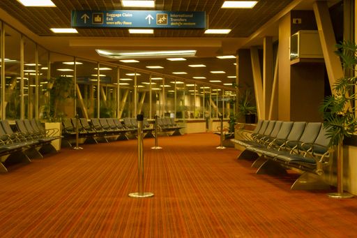 Mumbai international Airport, India, December 2011: Interior and hallway to baggage claim, exit or international transfers. Empty, with waiting seats