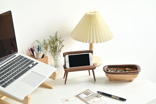 A closeup shot of a phone and a laptop on the desk