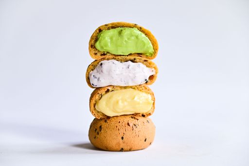A closeup shot of cookies with different flavors and colorful cream