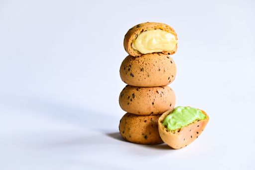 A closeup shot of cookies with different flavors and colorful cream