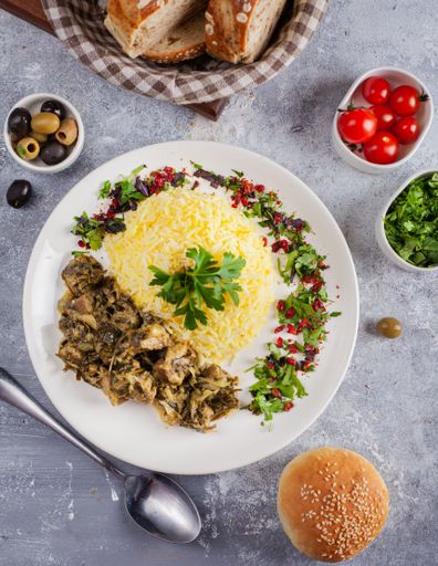 A vertical shot of a salad with cheese and mushrooms with different side dishes
