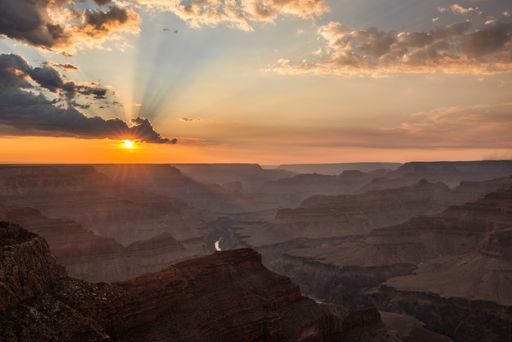 A beautiful high angle shot of beautiful sun rays spreading over the Grand Canyon, USA during the sunset