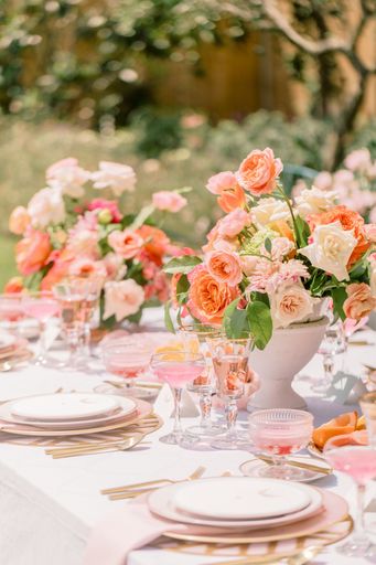 A vertical shot of an outdoor wedding table with flowers and elegant tableware