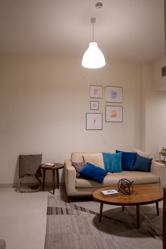 A spacious bright studio apartment in Scandinavian style and warm pastel white and beige colors, interior design, vertical