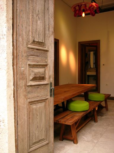 A vertical shot of the interior of a small cafe with an old wooden door in Alacati, Izmir, Turkey