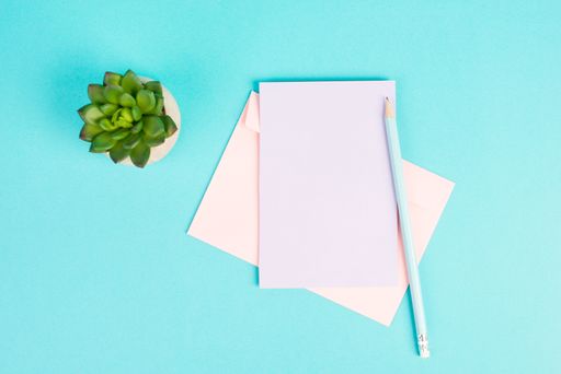 Empty paper with a pen and a cactus textured background, brainstorm ing for new ideas, writing a message, taking a break, home office desk