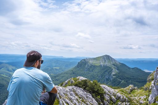 Caucasian male tourists on the top of the Aitzkorri mountain in Gipuzkoa