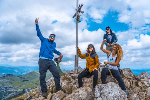 A group of Caucasian tourists on the top of the mount of Aitzkorri in Gipuzkoa