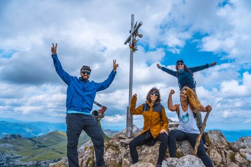A group of friends climbing to the top of Mount Aizkorri ascent
