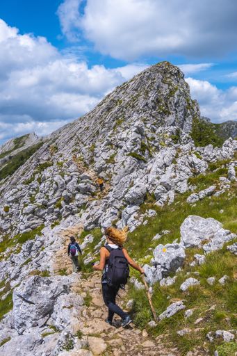 A group of friends climbing to the top of Mount Aizkorri ascent