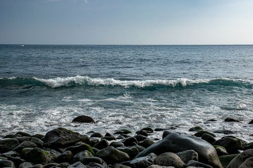 A beautiful view of ocean waves splashing on rocks in Madeira