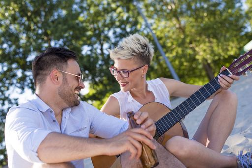 A shallow focus shot of a young Caucasian couple having fun on the beach
