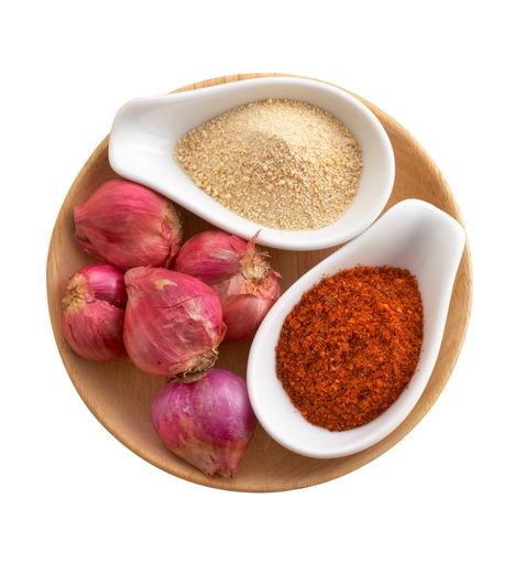 A top view of herbs of Thai cuisine on a  wooden tray isolated on a white background