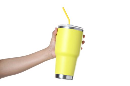 A hand holding colorful stainless steel thermos mugs with a straw isolated on a white background