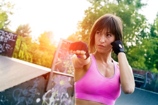 A shallow focus shot of a sporty Caucasian female doing workout in the park