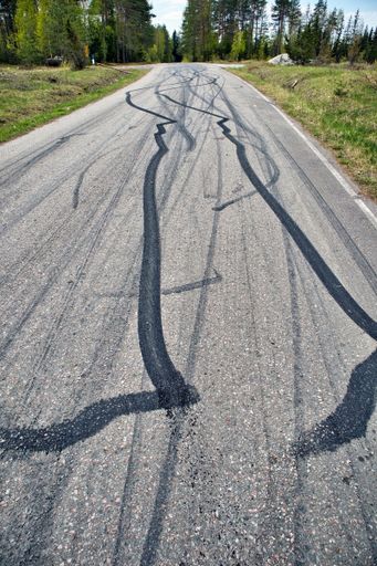 A vertical shot of black tire marks on the road
