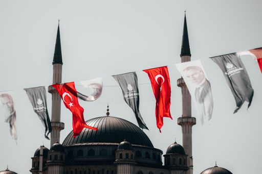 Holiday Turkish flags against the background of Mosque on Taksim square in Istanbul.