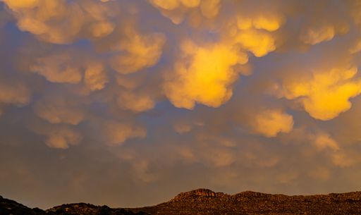 Cumulus and Stratus clouds in dramatic sunset sky over Cape Town South Africa