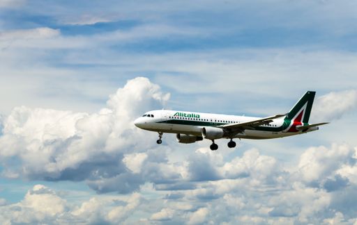 A stunning view of the Alitalia Airbus A320 plane flying high above clouds