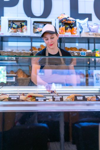 enterprising woman serving some freshly made cakes