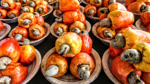 A high angle shot of colorful cashew fruits in a market