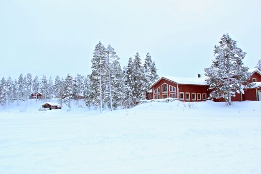 A red house in the snowy forest in Lapland