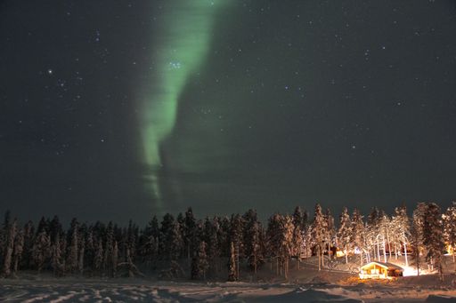 A mesmerizing shot of a landscape under the Northern Lights in Lapland