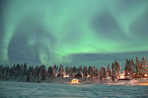 A mesmerizing shot of a landscape under the Northern lights in Lapland