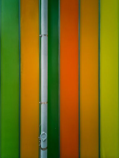 A vertical shot of a wall with colorful textures - perfect for a cool wallpaper or background
