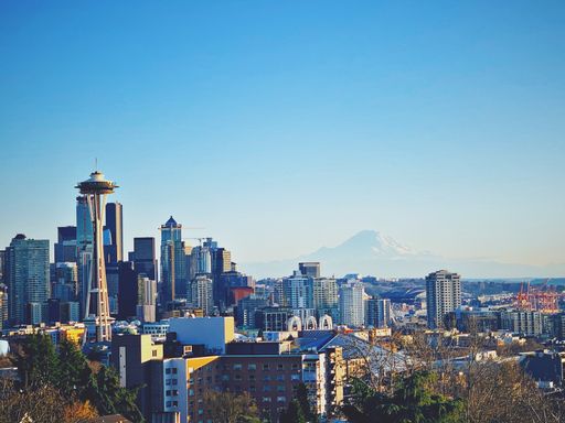 A gorgeous view of Seattle, Washington with Space Needle under a clear sky and Mount Rainier in the distance
