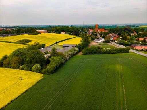 An aerial view of a beautiful field on a cloudy day in Boeslunde, Denmark