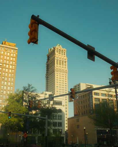 A beautiful view of a traffic light and high buildings under the clear sky