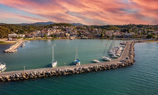 An aerial view of the picturesque port and the town against a cloudy sky at sunset