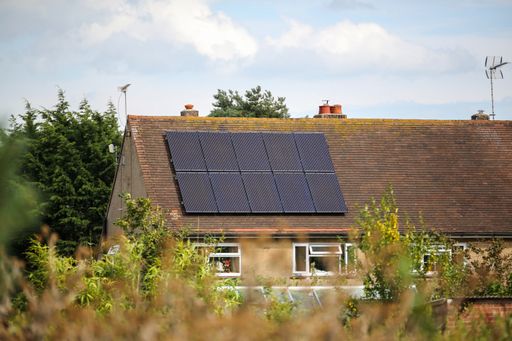 A selective focus shot of the solar panels on the roof of the house