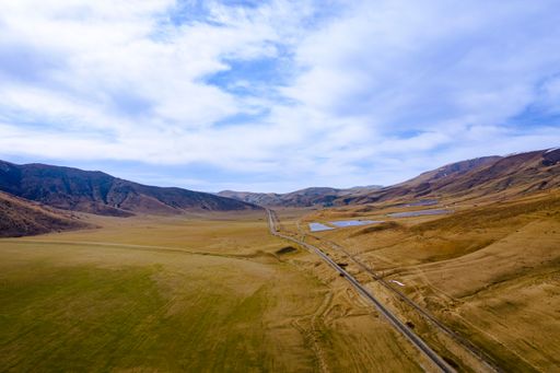 An aerial view of beautiful mountains under the blue cloudy sky in Armenia