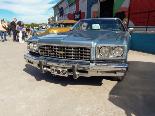 old Chevrolet Chevy Caprice 1975 two door hardtop by GM in a warehouse yard. Front view. Expo Fierro 2022 classic car show. Copyspace