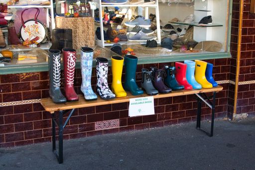 A beautiful shot of colorful boots out of a shop on a wooden table