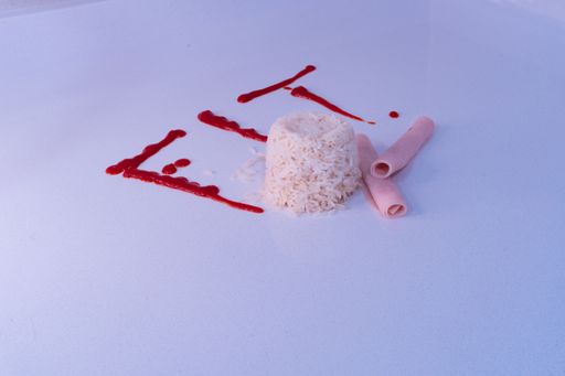 A closeup of the word Fit written in ketchup next to rice and folded ham